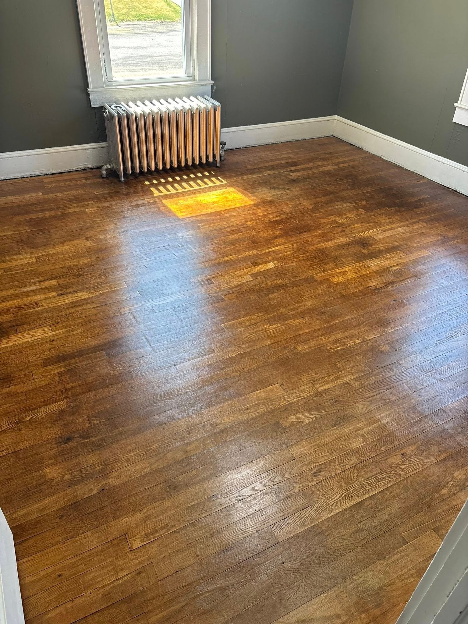 Wood floor shining where it was refinished and restored by ServiceFirst Clean & Restore in Charleston,WV